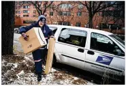  ?? RICHARD TSONG-TAATARII / (MINNEAPOLI­S) STAR TRIBUNE ?? Postal officials said finances may be aided by a strong holiday season of package deliveries and a first-class stamp price hike.