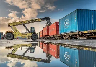  ?? STUFF ?? Containers are loaded on rail wagons at Ports of Auckland, where ships have been waiting up to 17 days to berth.