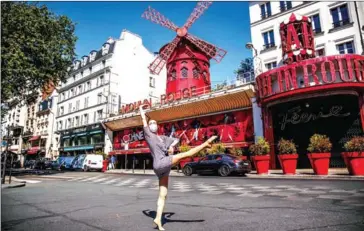  ?? AFP ?? Syrian dancer and choreograp­her Yara al-Hasbani performs a dance in front of the Moulin Rouge cabaret in Paris on April 22 last year.