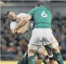  ??  ?? Ireland’s Peter O’Mahony tackles England’s Mark Wilson on Saturday.