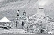  ?? ?? Heath with British Empire Medal; above, right, restoring the roof at Bearnais bothy in the Highlands