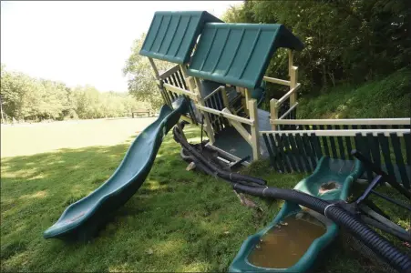  ?? Bill Uhrich — MeDiAnewS groUP ?? Playground equipment lies crumbled in ironstone Park after being swept away during the ironstone creek flooding on July 11.