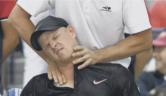  ??  ?? Britain’s Kyle Edmund receives treatment on his neck from a trainer during his third round match against Denis Shapovalov of Canada. Edmund was forced to retire in the fourth set.
