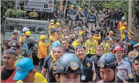  ?? LINH PHAM GETTY IMAGES ?? Hundreds of rescuers and equipment is still being sent inside Tham Luang Nang Non cave to continue the rescue operation after the 12 boys and their soccer coach were found alive.