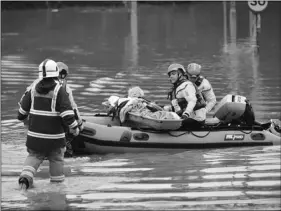  ?? BEN BIRCHALL/PA VIA AP ?? A member of the public is rescued after flooding in Nantgarw, Wales, on Sunday.