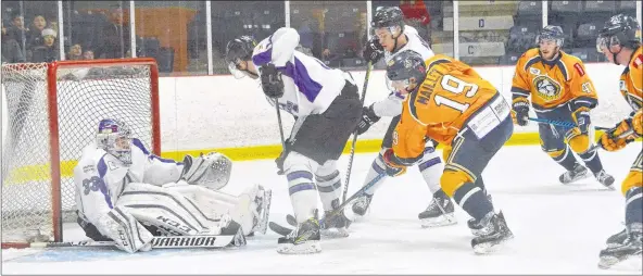  ?? TINA COMEAU ?? Ramblers goalie Joel Goguen is knocked down as the play continues on this scoring chance by the Mariners in a Feb. 9 game. Amherst held Yarmouth off on this play but Yarmouth had the 2-1 victory in overtime.