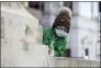  ?? PAT NABONG — CHICAGO SUN-TIMES VIA AP ?? Jackson Irons looks at the Chicago River in the Loop, which was dyed green ahead of St. Patrick’s Day in Chicago.