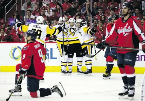  ?? PATRICK SMITH / GETTY IMAGES ?? The Pittsburgh Penguins celebrate Bryan Rust’s goal in Wednesday’s series- clinching win over the Capitals.