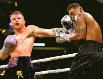  ?? John Locher Associated Press ?? CANELO ÁLVAREZ, left, lands a left jab against Jermell Charlo during their super middleweig­ht title match on Saturday in Las Vegas. Álvarez was in complete control from the outset in the unanimous decision victory.