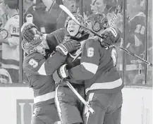  ?? Chris O'Meara / Associated Press ?? Tampa Bay’s Ondrej Palat, center, celebrates with Tyler Johnson, left, and Anton Stralman after Palat’s goal in the first.