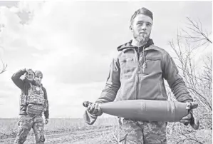  ?? AP/EFREM LUKATSKY ?? UKRAINIAN soldiers carry shells to fire at Russian positions on the front line, near the city of Bakhmut, in Ukraine’s Donetsk region, on March 25, 2024. Approval by the US House of a $61 billion package for Ukraine puts the country a step closer to getting an infusion of new firepower. But the clock is ticking. Russia is using all its might to achieve its most significan­t gains since the invasion by a May 9 deadline.