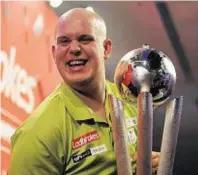  ??  ?? Michael van Gerwen with the Sid Waddell Trophy