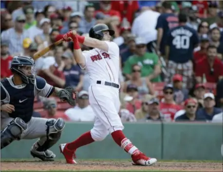  ?? STEVEN SENNE — THE ASSOCIATED PRESS ?? Boston Red Sox’s Andrew Benintendi, right, takes his at bat as New York Yankees’ Gary Sanchez, left, looks on in the eighth inning of a baseball game, Sunday in Boston.