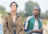  ??  ?? Charlize Theron (left) and Kiki Layne in a scene from The Old Guard, premiering on July 10 on Netflix.