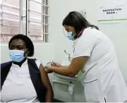 ?? /Michael Pinyana ?? Frontline first: Nurse Lindiwe Ngoni gets her vaccine from Sister Heidi Fourie at East London’s Frere Hospital.