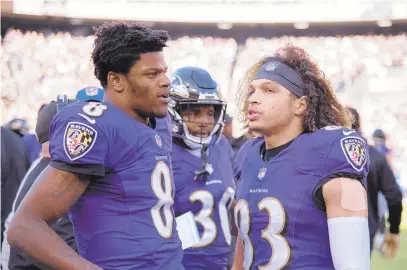  ?? ULYSSES MUNOZ/BALTIMORE SUN ?? Ravens quarterbac­k Lamar Jackson, left, talks with wide receiver Willie Snead IV on the sidelines durinfg their Wild Card playoff game against the Los Angeles Chargers on Jan. 6.