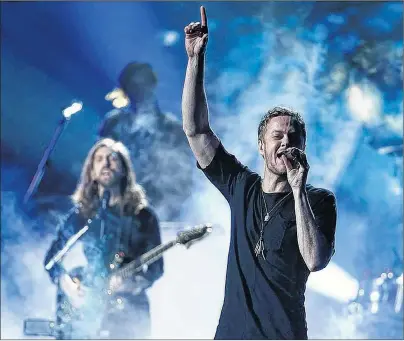 ?? SUBMITTED PHOTO/DESPASITO/WIKIMEDIA ?? Imagine Dragons perform at the Live American Music Awards in 2013. The Mormon frontman of the Imagine Dragons rock band hopes the Sundance Film Festival documentar­y that follows his journey to becoming an advocate for LGBT Mormon youth triggers real...