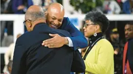  ?? KIM HAIRSTON/BALTIMORE SUN ?? Maryland Gov. Wes Moore hugs Kurt Schmoke, president of the University of Baltimore, before Saturday’s CIAA men’s basketball tournament final between Winston-Salem State and Lincoln at CFG Bank Arena.