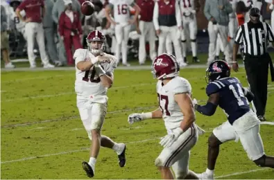  ?? Associated Press ?? Alabama quarterbac­k Mac Jones throws a 3-yard touchdown pass to tight end Miller Forristall in the second half of the Crimson Tide’s 63-48 win last Saturday in Oxford, Miss.