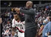 ?? DAVID ZALUBOWSKI — THE ASSOCIATED PRESS ?? Portland Trail Blazers head coach Chauncey Billups, front, directs forward Norman Powell in the first half of an NBA basketball game against the Denver Nuggets, Sunday in Denver.
