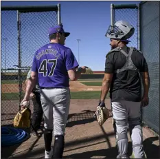  ?? AARON ONTIVEROZ — THE DENVER POST ?? Cal Quantrill and Elias Diaz of the Colorado Rockies talk as they walk to the bullpen during spring training Feb. 22 at Salt River Fields in Scottsdale, Ariz.