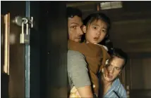  ?? COURTESY OF UNIVERSAL PICTURES ?? Ben Aldridge, left, with Kristen Cui and Jonathan Groff in a scene from “Knock at the Cabin.”