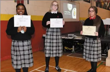  ??  ?? Irish certificat­e winners Kirsty Lee Joyce, Linda Rathena and Ohemaah Wiredu at the Ó Fiaich College Junior Cycle Awards Ceremony.