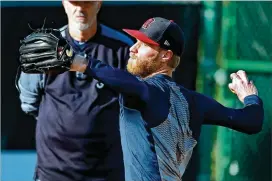  ?? CURTIS COMPTON / CCOMPTON@AJC.COM ?? Mike Foltynewic­z (working in the bullpen as coach Rick Kranitz watches) could return in the second week of the season, but may be out longer.