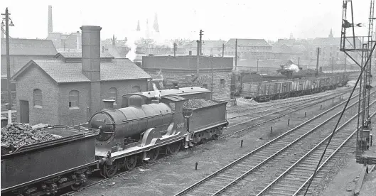  ?? Colour-Rail.com/13361 ?? The Carstairs to Edinburgh (Princes Street) main line is in the foreground as we look north across the Dalry Road shed site in July 1953 and see McIntosh ‘43’ class (LMS ‘3P’) 4-4-0 No 54452 between duties. New from St Rollox Works as CR No 45 in 1913, rather curiously the long-term latter day Dalry Road allocation of this ‘Superheate­d Dunalastai­r IV’ was interrupte­d in February/March 1951 by a loan period to the Mechanical & Electric Engineers, Princes Street. Back at home, the latter day work of the ‘Caley Bogies’ based here often involved spells working from Slateford carriage sidings; No 54452 would serve until July 1957. Other locomotive­s on hand include a ‘Crab’ class 2-6-0, an ex-NBR 0-6-0 and a CR ‘Passenger Tank’, the Leith and Granton route passing to the north of these.