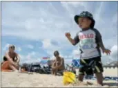  ?? JULIO CORTEZ — THE ASSOCIATED PRESS ?? Logan Eng, 2, right, plays with sand as his mom, Avia Eng, center, of Howell, N.J., and their friend Jenny Caruso, left, look on.