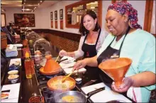  ?? STEVE MACNAULL/The Okanagan Weekend ?? Kerry MacNaull makes chicken tagine with chef Yahya at La Maison Arabe’s cooking school. Right, a snake charmer and his cobras in Jemmael-Fna Square in Marrakech.