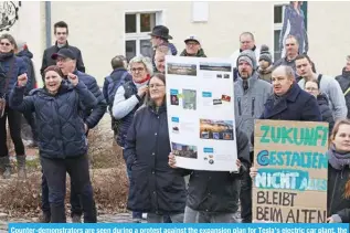  ?? ?? Counter-demonstrat­ors are seen during a protest against the expansion plan for Tesla’s electric car plant, the company’s only European production site, near the plant in Gruenheide, east of the German capital Berlin on March 10, 2024. -- AFP
