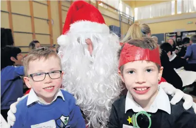  ??  ?? Oh brother! Rory Thorrat, left, and his brother, Lucas, meet Santa