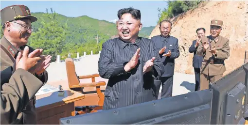  ?? KCNA VIA AFP/ GETTY IMAGES ?? North Korean leader Kim Jong Un celebrates the test of an interconti­nental ballistic missile, purportedl­y on July 4.