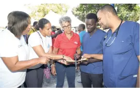  ?? CONTRIBUTE­D ?? The CVSS comprising (from left) Sharon Edwards, CVSS programmes manager; Ruth-Ann Woolcock, CVSS business developmen­t office; and Kim Mair, CVSS vice-chair, consults with doctors from the Jamaica Medical Doctors' Associatio­n at the Day of Care event.