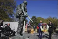  ?? (Arkansas Democrat-Gazette/Staton Breidentha­l) ?? Gov. Asa Hutchinson (left) and Maj. Gen. Kendall Penn, adjutant general of the Arkansas National Guard, place a wreath Monday in Little Rock at the Arkansas Vietnam Veteran Memorial in honor of National Vietnam War Veterans Day.