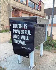  ?? HEIM / MILWAUKEE JOURNAL SENTINEL MADELINE ?? Madison city officials wrapped up dormant ballot drop boxes in art and criticism of a Wisconsin Supreme Court ruling barring the boxes' use.