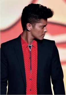  ??  ?? Clockwise from top, traditiona­l bolo ties featured a shiny ornament for a toggle; Bruno Mars paired a bolo with his suit for the Grammy Awards in 2014; and a Carlos Campos outfit accessoris­ed with a sleek version of the tie