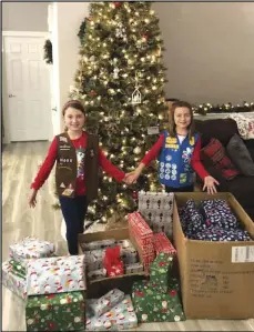  ?? Photo provided ?? Hannah Hullinger (left) and Reagan Nale (right) pose with presents the collected for Angel Tree Project.