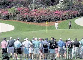  ?? AP ?? Bryson DeChambeau, center, and Phil Mickelson putt on the 13th green during a practice round for the Masters on Wednesday.