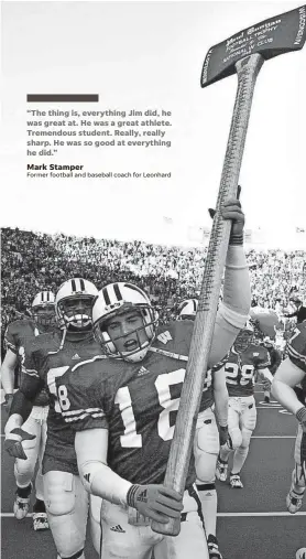  ?? ANDY MANIS/AP ?? Wisconsin's Jim Leonhard holds up the Paul Bunyan ax after Wisconsin beat Minnesota, 49-31, in Madison on Nov. 23, 2002. Leonhard had two intercepti­ons in the game.