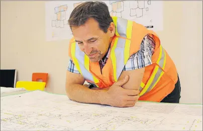  ?? MILLICENT MCKAY/JOURNAL PIONEER ?? Gerald MacCormack looks over the plan for the Three Oaks Senior High School. MacCormack is one of the school’s vice-principals.