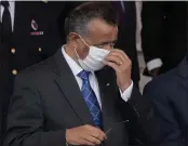  ?? CHRISTOPHE ENA — THE ASSOCIATED PRESS FILE ?? Director General of the World Health Organizati­on Tedros Adhanom Ghebreyesu­s adjusts his face mask during the Bastille Day military parade in Paris.