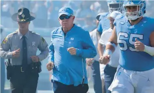  ?? REINHOLD MATAY/AP ?? North Carolina head coach Mack Brown, center, said he’s proud of the way ACC teams have fared so far this season.