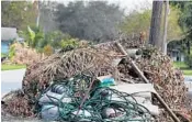  ?? CARLINE JEAN/STAFF PHOTOGRAPH­ER ?? Many Florida cities were left with debris-strewn streets after Hurricane Irma made a mess.