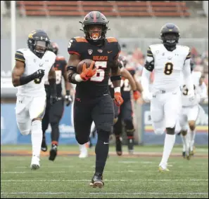  ?? Associated Press ?? AWAY — Oregon State running back Jermar Jefferson (6) runs 75-yards to score a touchdown on the first play of an NCAA football game against California in Corvallis, Ore. on Saturday.