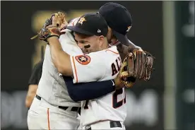  ?? DAVID J. PHILLIP — THE ASSOCIATED PRESS ?? Houston Astros shortstop Carlos Correa celebrates their win with Jose Altuve against the Boston Red Sox in Game 1of baseball’s American League Championsh­ip Series Friday, Oct. 15, 2021, in Houston.