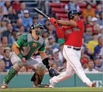  ?? Matt Stone
/ Media News Group / Boston Herald ?? Rafael Devers of the Boston Red Sox hits a two run homer scoring Jackie Bradley Jr. during the second inning of the MLB game against the Oakland Athletics on Wednesday in Boston, Massachuse­tts.