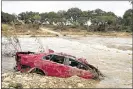  ?? JAY JANNER / AMERICAN-STATESMAN ?? A wrecked car is submerged in the Blanco River in Wimberley on Tuesday after the area’s devastatin­g flooding.