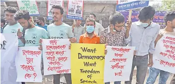  ?? — AFP photo ?? Activists hold placards during a demonstrat­ion demanding the repeal of the Digital Security Act, in Dhaka following the death of writer Mushtaq Ahmed in jail months after his arrest under internet laws which critics say are used to muzzle dissent.